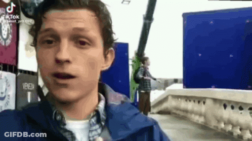 Man In Blue Jacket By Blue Building GIF