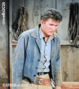 Man In Blue Jacket By Wall With Ropes 2026 GIF