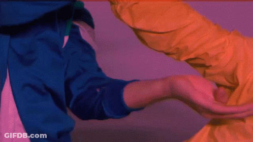 Man In Blue Jacket Carrying Man In Yellow Jacket GIF