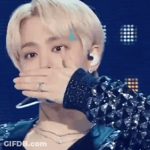 Man In Blue Jacket Covering Mouth GIF