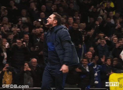Man In Blue Jacket Dancing In Front Of Crowd With Yellow Vest Saying Heitse GIF
