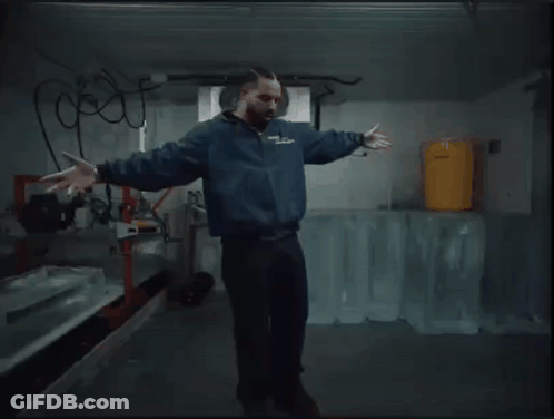 Man In Blue Jacket Dancing With Ice Blocks GIF