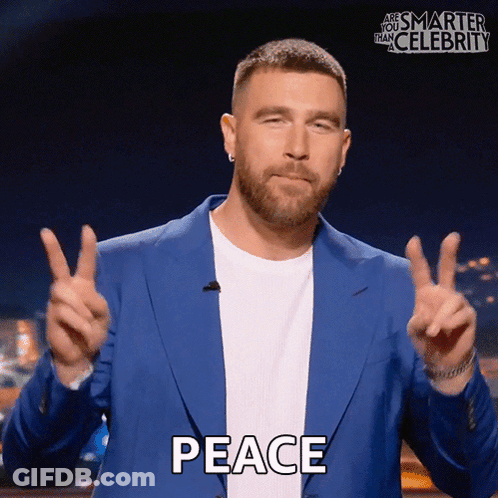 Man In Blue Jacket Giving Peace Sign GIF