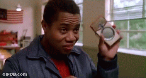 Man In Blue Jacket Holding Box And Magnifying Glass GIF