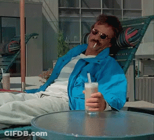 Man In Blue Jacket Holding Drink GIF