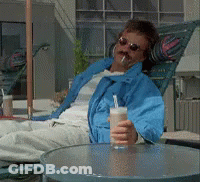 Man In Blue Jacket Holding Drink GIF