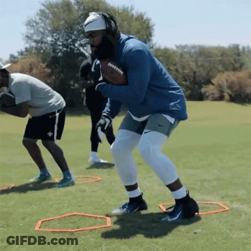 Man In Blue Jacket Holding Football GIF