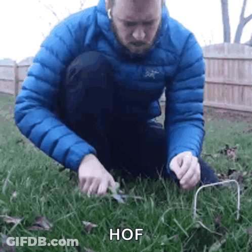Man In Blue Jacket Holding Wire GIF