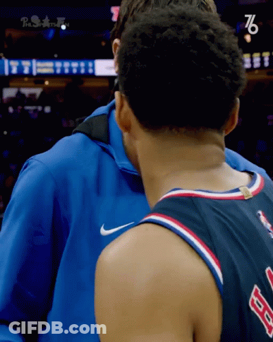 Man In Blue Jacket Hugging 76 Jersey GIF