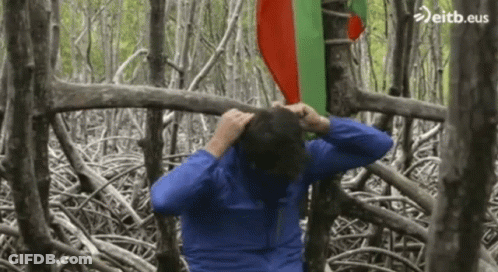 Man In Blue Jacket In Forest With Eitb.eus GIF