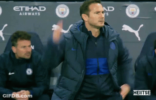 Man In Blue Jacket In Front Of Etihad Airways Banner GIF
