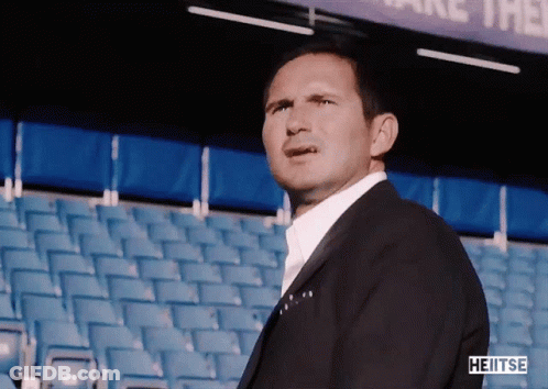 Man In Blue Jacket In Front Of Etihad Airways Banner GIF