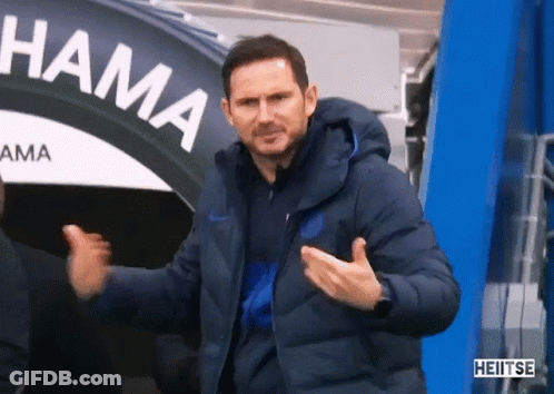 Man In Blue Jacket In Front Of Hama Sign GIF