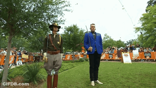 Man In Blue Jacket In Front Of Home Depot Sign GIF