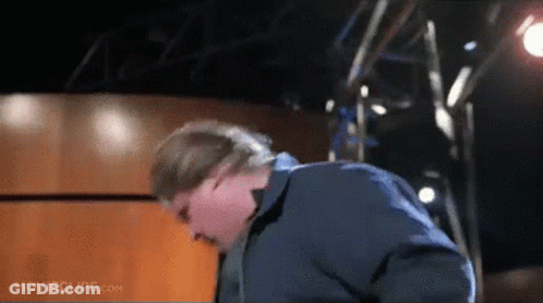Man In Blue Jacket In Front Of Movie Clips Sign GIF