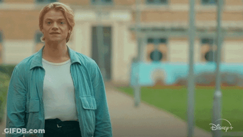 Man In Blue Jacket In Front Of Sign Saying I Kn GIF
