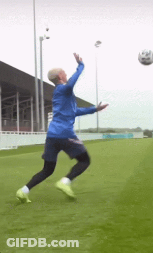 Man In Blue Jacket Jumping For Soccer Ball GIF