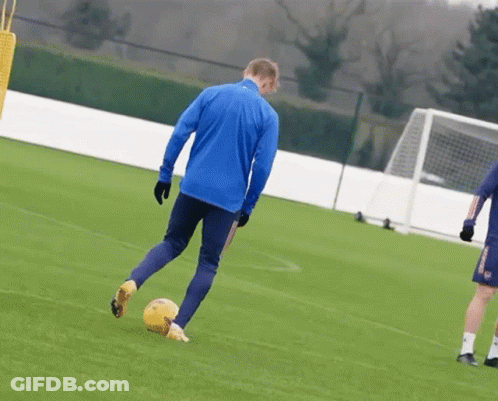 Man In Blue Jacket Kicking Soccer Ball GIF