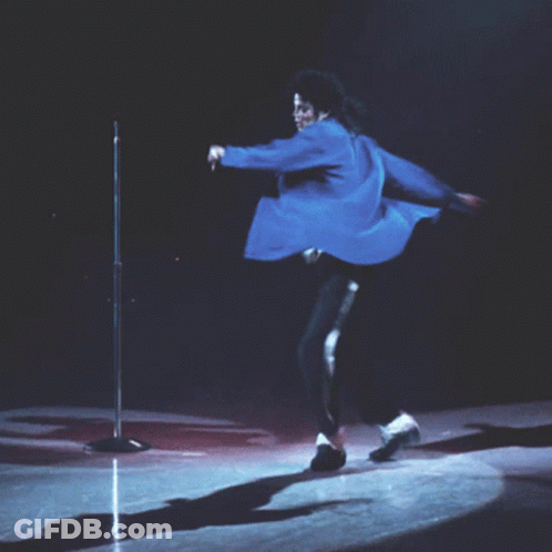 Man In Blue Jacket Kneeling At Microphone GIF