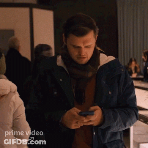 Man In Blue Jacket Looking At Phone Prime Video GIF