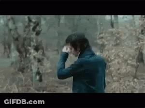 Man In Blue Jacket Looking Through Binoculars In Foggy Forest GIF