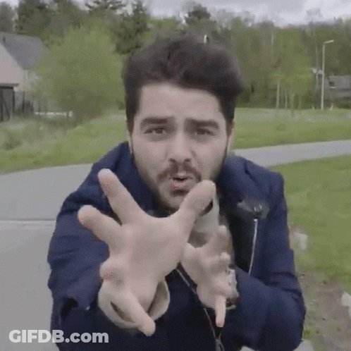 Man In Blue Jacket Making Funny Face With Hands GIF