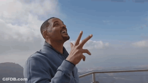 Man In Blue Jacket Making Peace Sign GIF