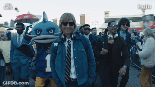 Man In Blue Jacket Number 02 In Front Of Crowd GIF