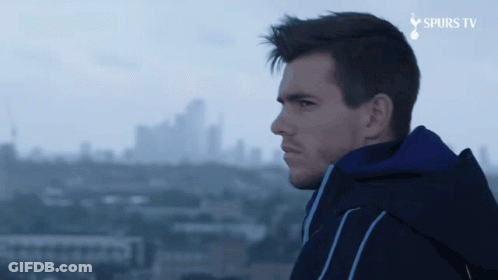 Man In Blue Jacket Overlooking City With Spurs TV GIF