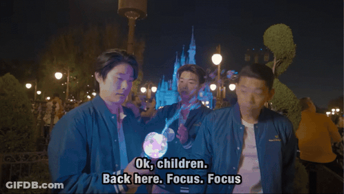 Man In Blue Jacket Says Ok Children Back Here Focus Focus In Front Of Castle GIF