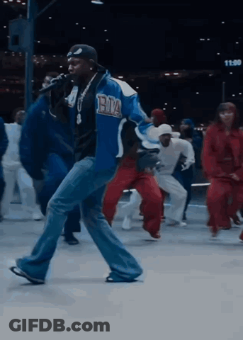 Man In Blue Jacket Singing Into Microphone GIF