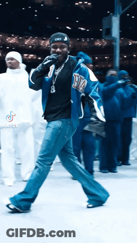 Man In Blue Jacket Singing Into Microphone GIF