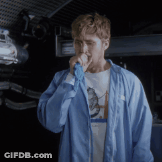 Man In Blue Jacket Singing Into Microphone With Space Shirt GIF