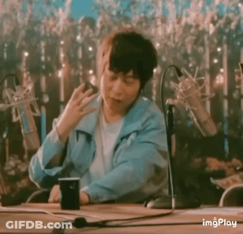Man In Blue Jacket Sitting At Table GIF