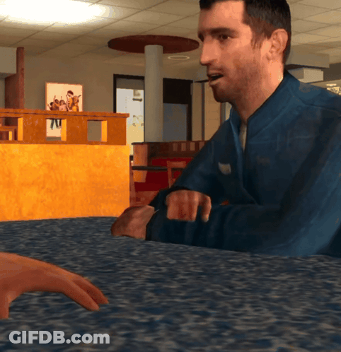 Man In Blue Jacket Sitting At Table With Another Man GIF