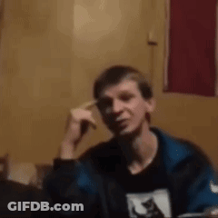 Man In Blue Jacket Sitting With Hand On Head GIF