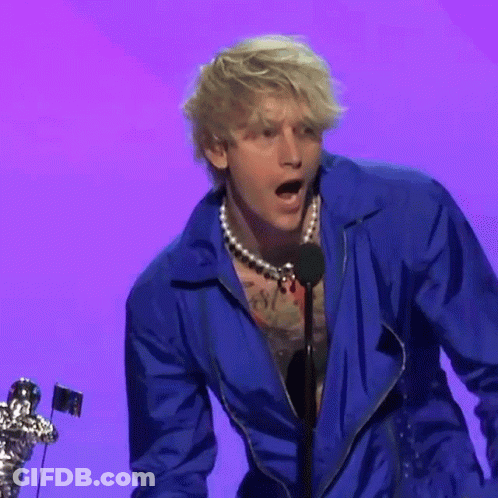 Man In Blue Jacket Speaking Into Microphone On Stage GIF