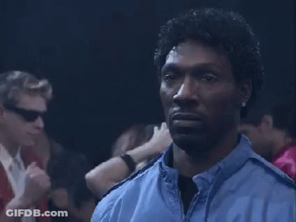 Man In Blue Jacket Standing In Crowd GIF