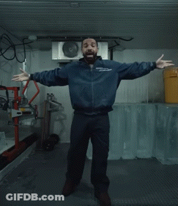 Man In Blue Jacket Standing With Yellow Bucket GIF
