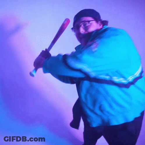 Man In Blue Jacket Swinging Bat GIF