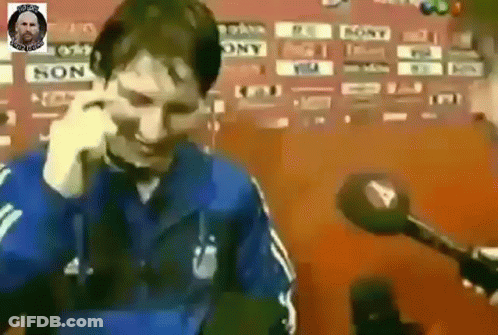 Man In Blue Jacket Talking On Cell Phone With Microphone GIF