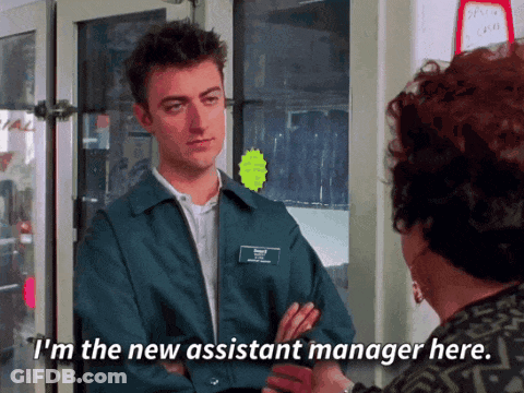 Man In Blue Jacket Talking To New Assistant Manager GIF