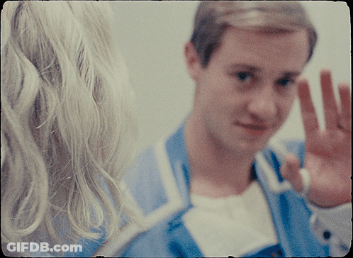 Man In Blue Jacket Waves To Woman GIF