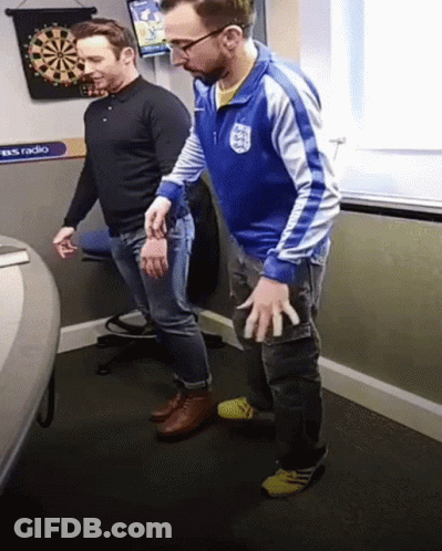 Man In Blue Jacket With England Next To Another Man GIF