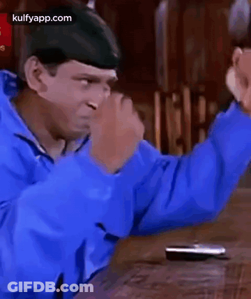 Man In Blue Jacket With Hands In The Air GIF