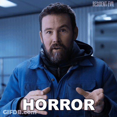 Man In Blue Jacket With Horror Written On Face GIF