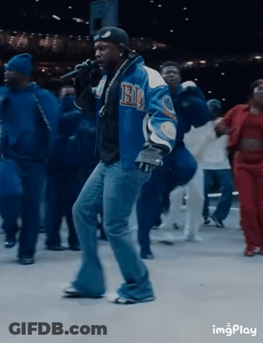 Man In Blue Jacket With Letter H In Front Of Crowd GIF