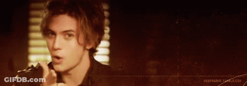 Man In Blue Jacket With Question Mark On Shirt GIF