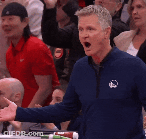 Man In Blue Jacket With Triangle Logo GIF