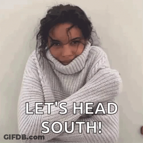 Man In Blue Jacket With White Collar Looking Down GIF